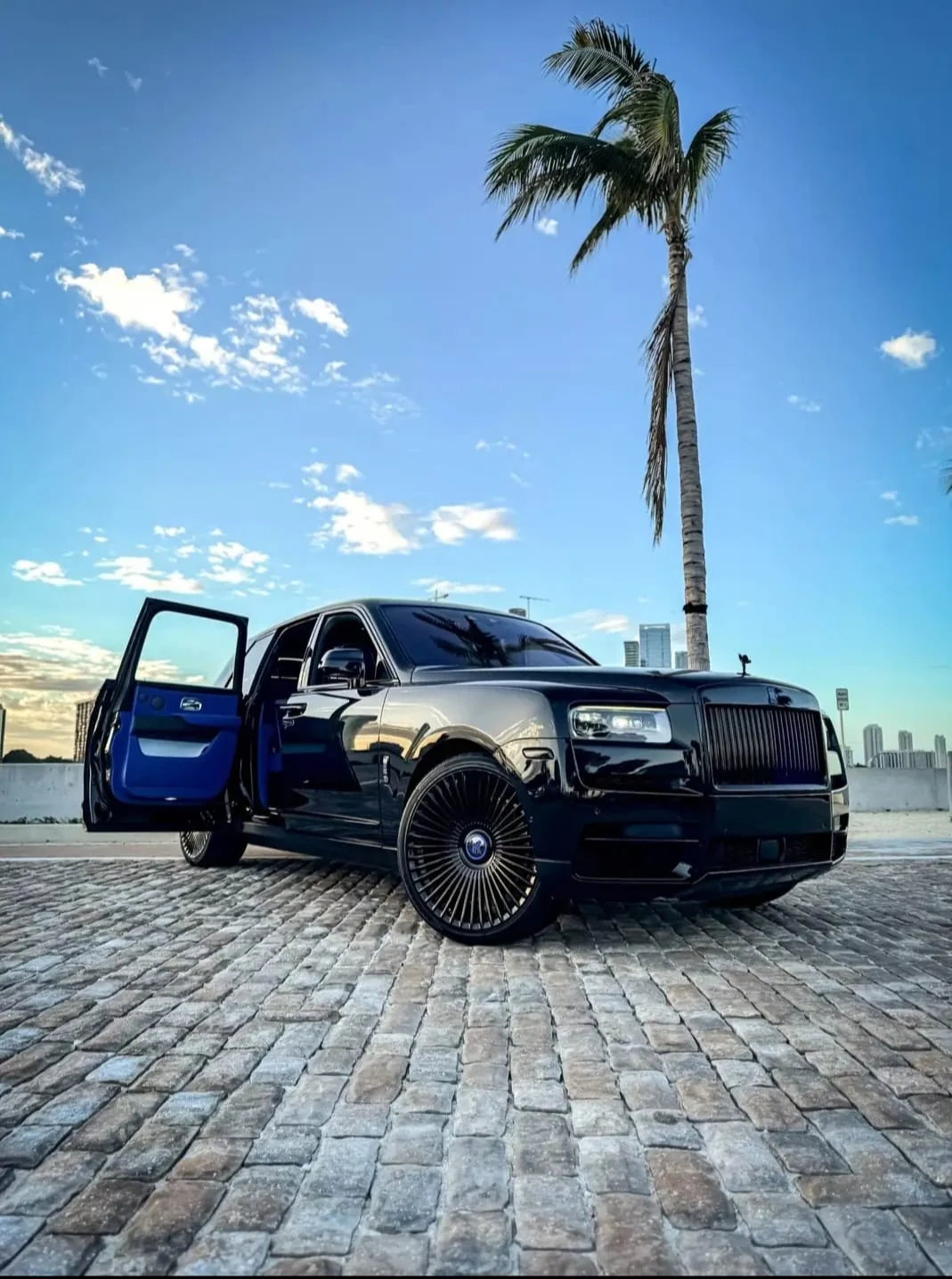 Black Rolls-Royce Cullinan with rear door open